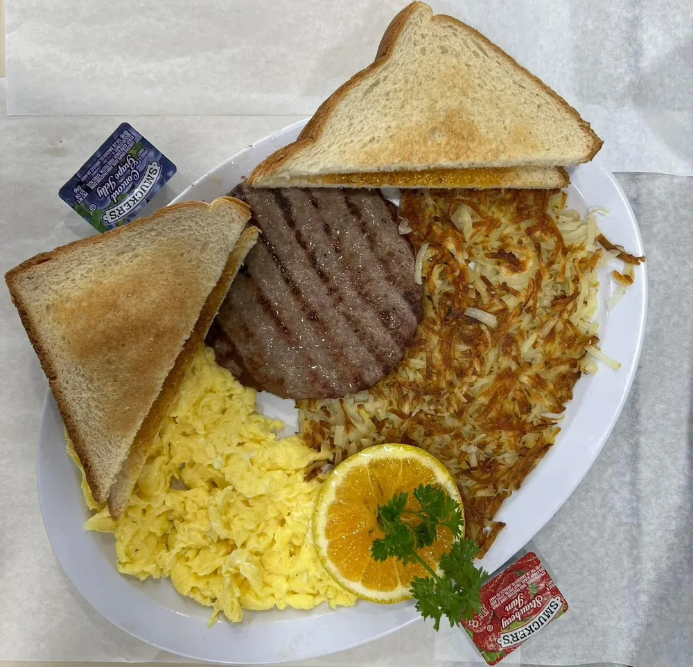 Hamburger patty and egg sandwich plate at Omega Burgers